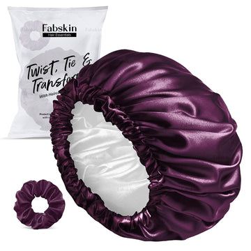Purple satin hair bonnet and scrunchie with Fabskin packaging on a white background