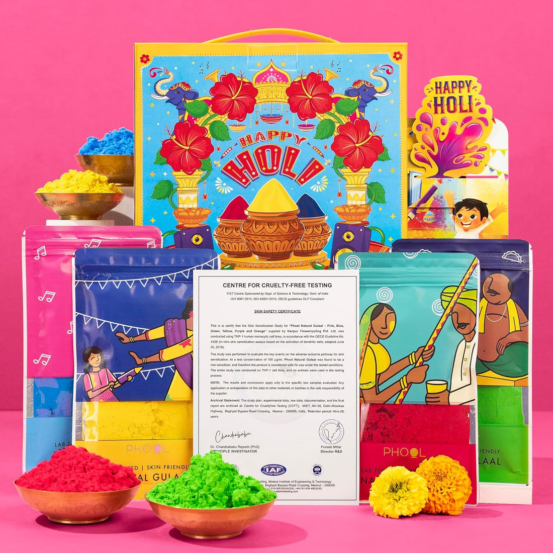 Colorful Holi gift set with traditional items on a pink background