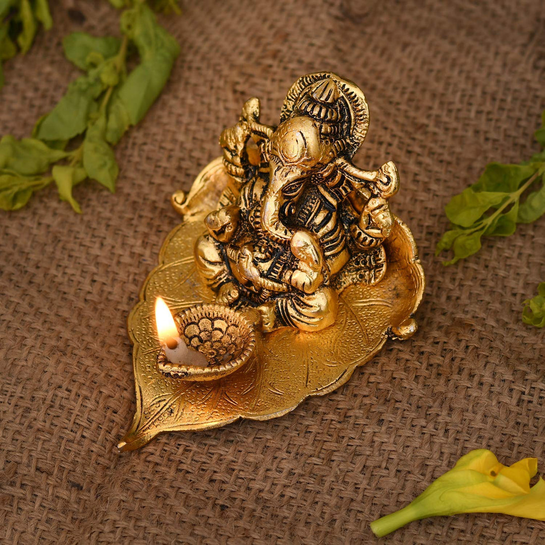 Lord Ganesha on Leaf with Diya