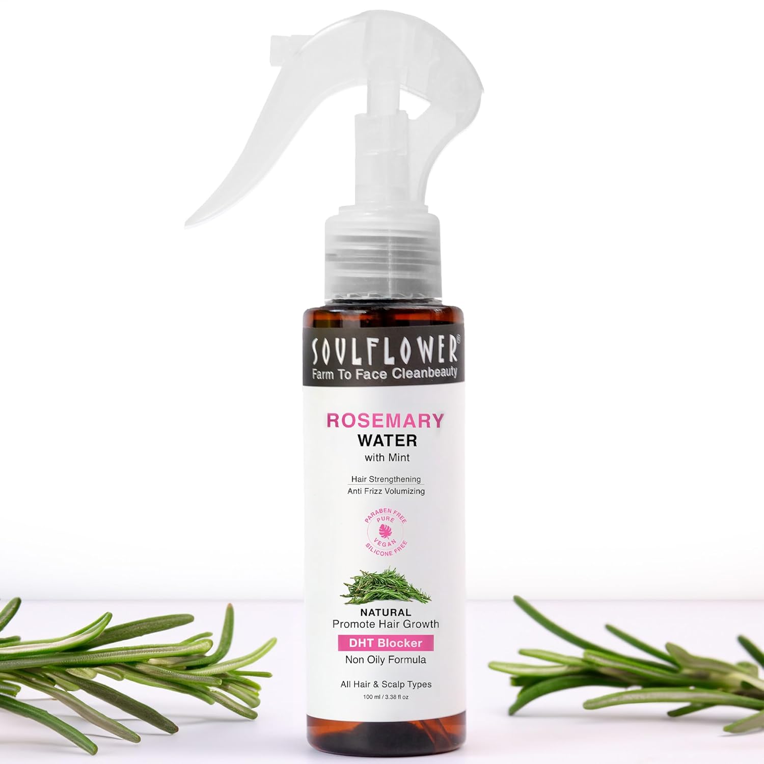 Soulflower Rosemary Water spray bottle with rosemary leaves on a white background
